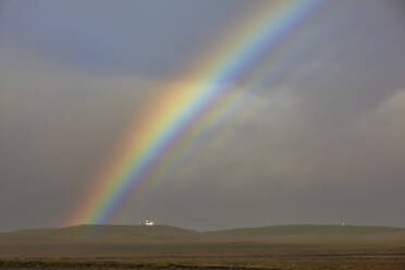 A rainbow arches over a church in countryside near the town of Rif, Snaefellsnes peninsula, in western Iceland, Polar Regions - RHPLF26214