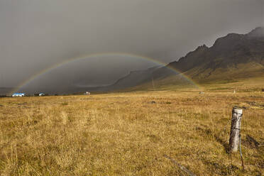 A rainbow arcs across countryside near the town of Stykkisholmur, Snaefellsnes peninsula, west coast of Iceland, Polar Regions - RHPLF26226