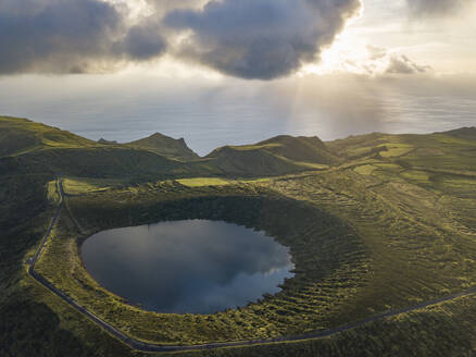 Aerial view of Caldeira Rasa lake on Flores island and the sunset over the sea, Azores islands, Portugal, Atlantic, Europe - RHPLF26265