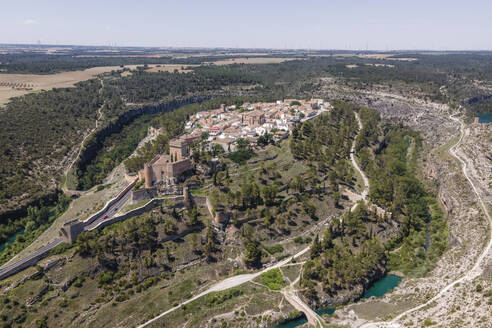 Aerial view of Alarcon, a medieval town with castle on top along the Rio Jucar river in Cuenca, Spain. - AAEF20559