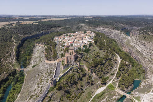 Aerial view of Alarcon, a medieval town with castle on top along the Rio Jucar river in Cuenca, Spain. - AAEF20560