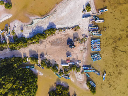 Aerial view of the resting area of fishermen with fishing boats docked along the shore at Chelem, Yucatan, Mexico. - AAEF20592