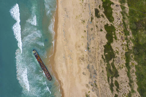 Aerial view of a rusty abandon ship at the beach in Tarkwa Bay, Lagos, Nigeria. - AAEF20705