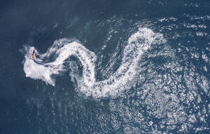 Aerial view of a water bike forming a white snake like trail in the water, Acre, Northern District, Israel. - AAEF20751