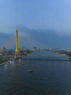 Aerial view of The Rama VIII Bridge, a cable-stayed bridge crossing the Chao Phraya River at night in Bangkok, Thailand. - AAEF20860