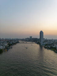 Aerial view of The Rama VIII Bridge, a cable-stayed bridge crossing the Chao Phraya River at night in Bangkok, Thailand. - AAEF20861