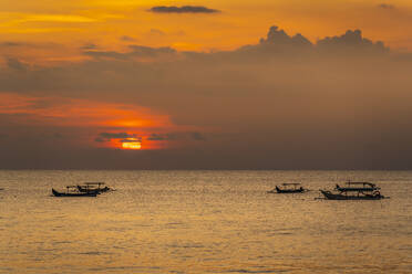 View of sunset and fishing outriggers on Indian Ocean from Kuta Beach, Kuta, Bali, Indonesia, South East Asia, Asia - RHPLF26313