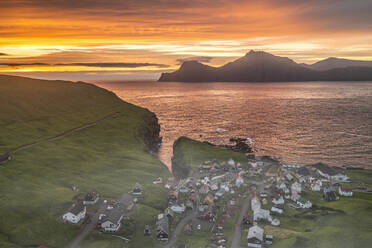 Fiery sky at dawn over Kalsoy island and the village of Gjogv, overhead view, Eysturoy Island, Faroe Islands, Denmark, Europe - RHPLF26413