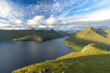 Clouds in the summer sky over mountains along a fjord, Eysturoy Island, Faroe Islands, Denmark, Europe - RHPLF26417