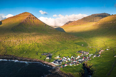 Aerial view of the coastal village of Gjogv and mountains at sunrise, Eysturoy Island, Faroe Islands, Denmark, Europe - RHPLF26424