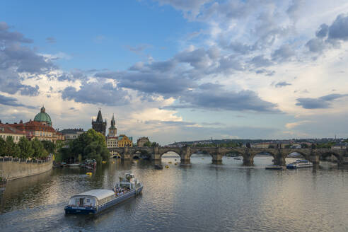 Boat going towards Charles Bridge and Old Town Bridge Tower, UNESCO World Heritage Site, Prague, Bohemia, Czech Republic (Czechia), Europe - RHPLF26481