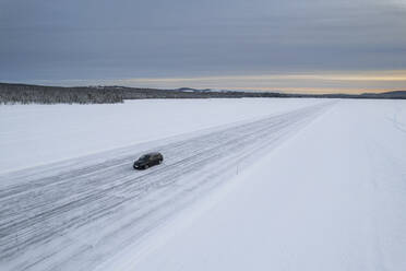 Car on icy road on a frozen lake from above, aerial view, Lapland, Sweden, Scandinavia, Europe - RHPLF26516