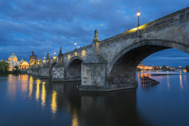 Low angle view of arches of Charles Bridge at twilight, UNESCO World Heritage Site, Prague, Bohemia, Czech Republic (Czechia), Europe - RHPLF26727
