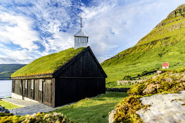 Traditional church with grass roof overlooking the fjord, Funningur, Eysturoy Island, Faroe Islands, Denmark, Europe - RHPLF26738