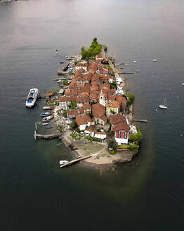 Aerial view of Isola Superiore, a small island with houses along the Lake Maggiore coastline, Borromee Islands, Italy. - AAEF20960