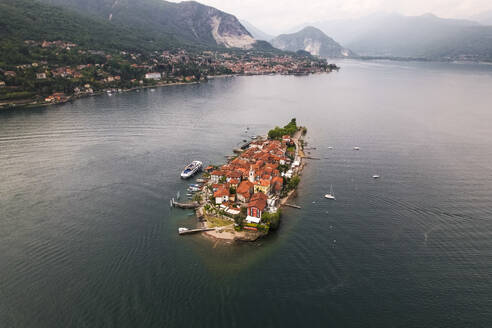 Aerial view of Isola Superiore, a small island with houses along the Lake Maggiore coastline, Borromee Islands, Italy. - AAEF20961