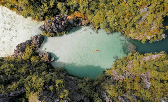 Aerial view of people with a kayak sailing across El Nido Bay, Palawan, Philippines. - AAEF21021