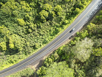 Aerial View of a car driving on Kaumualii Highway, West Kaua'i, Hawaii, United States. - AAEF21073