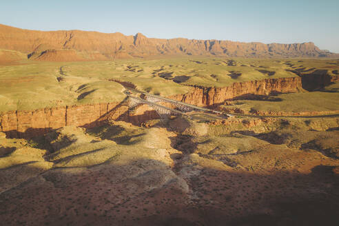 Aerial view of the Navajo Bridge over Colorado River next to Marble Canyon, Arizona, United States. - AAEF21136