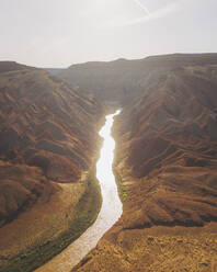 Aerial view of triangular shaped rocks along San Juan River, near Mexican Hat, Utah, United States. - AAEF21140