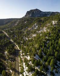 Aerial view of the snowy road with a panorama to Roof Butte, Arizona, United States. - AAEF21176