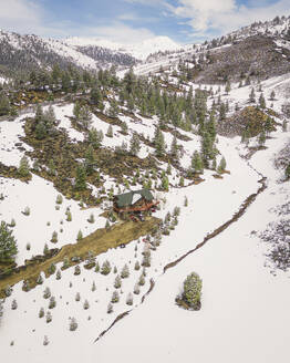 Aerial view of a snowy house along the Swauger Creek, California, United States. - AAEF21324