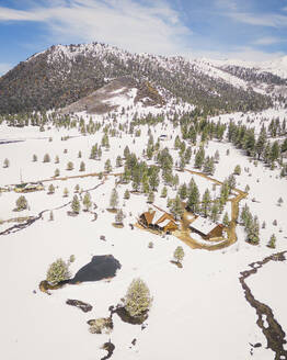 Aerial view of a snowy house along the Swauger Creek, California, United States. - AAEF21326