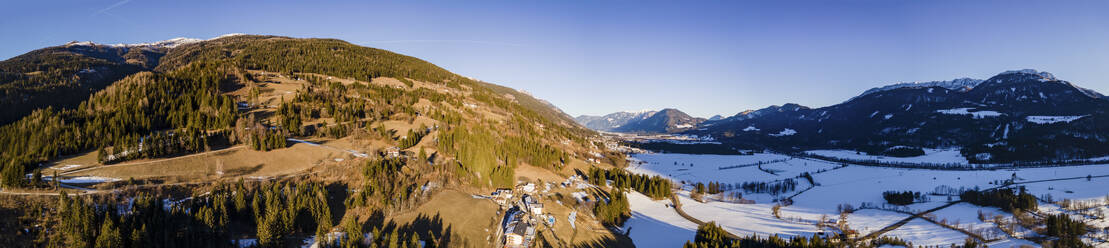 Aerial drone panoramic view in winter of Drava Valley at sunset, Berg im Drautal, Carinthia, Austria. - AAEF21409