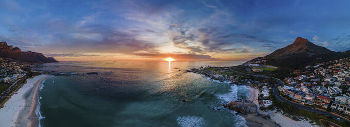 Panoramic aerial view of Camps Bay beach at sunset with Lion’s Head mountain and Table Mountain, Cape Town, South Africa. - AAEF21414