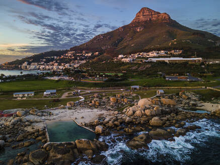 Aerial view of Maidens Cove tidal pool at sunset with Lions Head mountain in background, Cape Town, South Africa. - AAEF21415