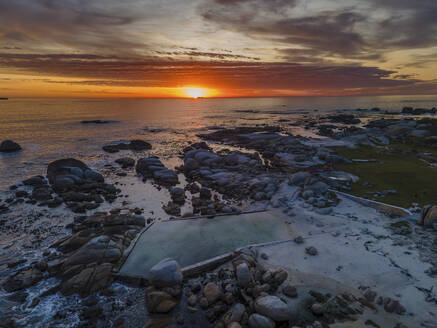 Aerial view of Maidens Cove tidal pool at sunset with Atlantic Ocean in background, Cape Town, South Africa. - AAEF21417