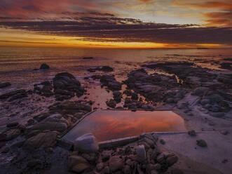 Aerial view of Maidens Cove tidal pool at sunset with Atlantic Ocean in background, Cape Town, South Africa. - AAEF21421