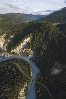 Aerial drone view of a canyon filled by a glacier river crossed by a railroad, Rheinschlucht, Flims, Graubunden, Switzerland. - AAEF21561