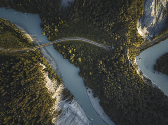 Aerial drone view of a canyon filled by a glacier river crossed by a railroad, Rheinschlucht, Flims, Graubunden, Switzerland. - AAEF21562