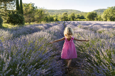 Carefree girl spending leisure time in lavender field - SVKF01586