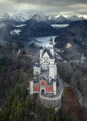 Aerial view of the Neuschwanstein Castle, a 19th-century historicist palace on a rugged hill of the foothills of the Alps in the very south of Germany. - AAEF21745