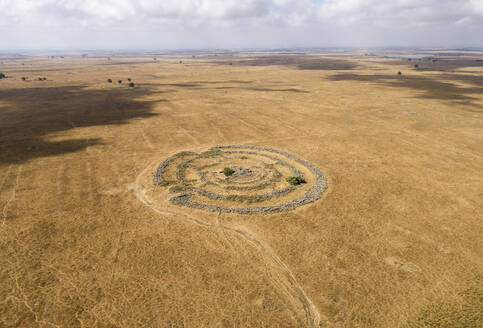 Aerial view of ancient megalithic monument site in the shape of 3 concentric stone circles, Rujum Al-Hiri, Golan Heights, Israel. - AAEF21765