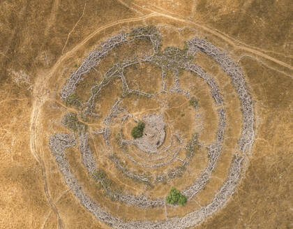 Aerial view of ancient megalithic monument site in the shape of 3 concentric stone circles, Rujum Al-Hiri, Golan Heights, Israel. - AAEF21766