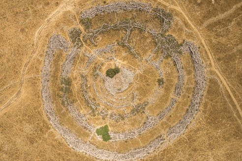 Aerial view of ancient megalithic monument site in the shape of 3 concentric stone circles, Rujum Al-Hiri, Golan Heights, Israel. - AAEF21769