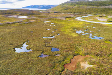 Aerial view of colourful lakes and a river flowing to the sea in Hraundalur, Westfjords, Iceland. - AAEF21782