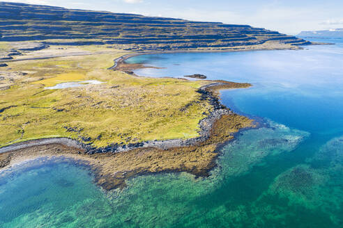 Aerial view of coastline along a fjord with clear water, Isafjardardjup, Westfjords, Iceland. - AAEF21783