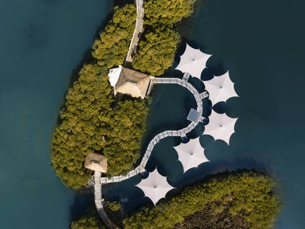 Aerial drone view of overwater houses built in the mangroves and connected by a board walk, Flacq, Mauritius, Indian Ocean. - AAEF21807