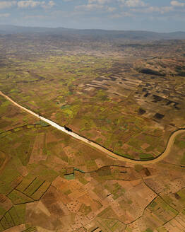 Aerial view of a stream of water across the valley in Vakinankaratra state, Madagascar. - AAEF21817