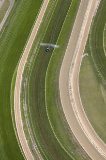 Aerial view of Horse Racing Track With Maintenance Tractor, Melbourne, Australia. - AAEF21835