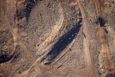 Aerial view of a person riding a dirt motorbike on a racing track in regional Australia, Melbourne, Victoria, Australia. - AAEF21852