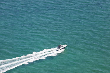 Aerial view of a speedboat sailing fast across the ocean, Melbourne, Victoria, Australia. - AAEF21862