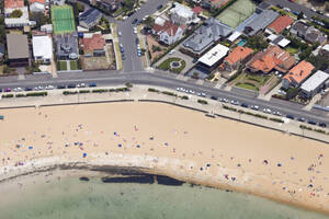 Aerial view of Williamtown beach with people along the shore on the beach, Melbourne, Victoria, Australia. - AAEF21867