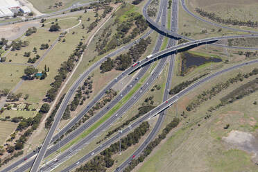 Aerial view of vehicles driving on a complex highway connection in Melbourne, Victoria, Australia. - AAEF21870