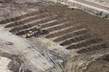 Aerial view of a heavy duty machinery working on a construction site in Melbourne, Victoria, Australia. - AAEF21873