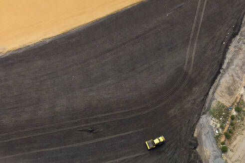 Aerial view of a heavy duty machinery working on a construction site in Melbourne, Victoria, Australia. - AAEF21874